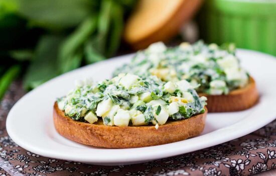 Sandwich with eggs salad, green herb, parsley, ramson, spring onions